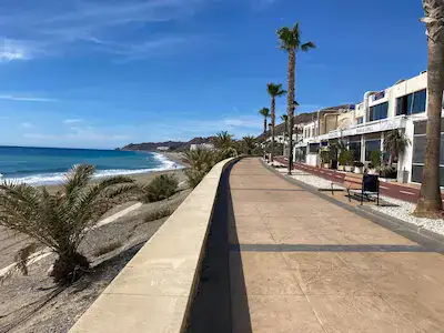 A flat paseo with low rise buildings on the right and the sea on the left. Ideal for cycling, flat walking or pushing a stroller.