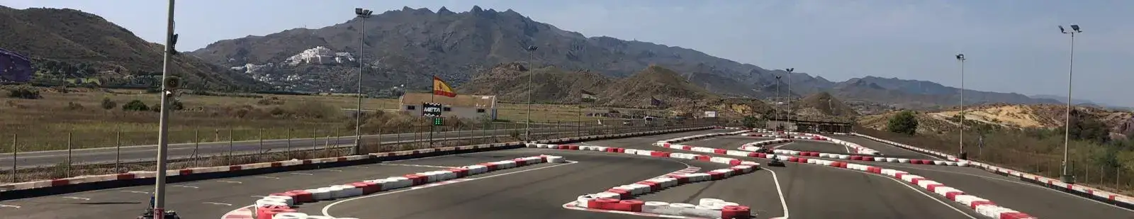 From the viewing platform at Karting Garrucha near Mojacar - a place for Go Carting. Looking at the track with some hills in the distance.
