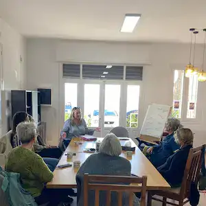 Training event showing Jeanna Park leading the group of ladies who are sitting around a large table