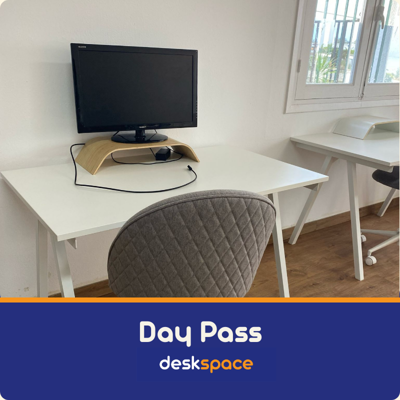 A picture taken from within DeskSpace Coworking Mojacar, Spain showing desk and external monitor on a riser - 2nd desk partially showing to the right of the picture.