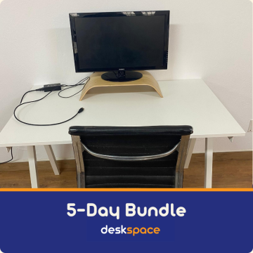 A picture taken from within DeskSpace Coworking Mojacar, Spain showing a white desk, and external monitor on a riser.